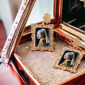 Vermeer’s ‘Girl with a pearl earring’ earrings!  Framed, no less